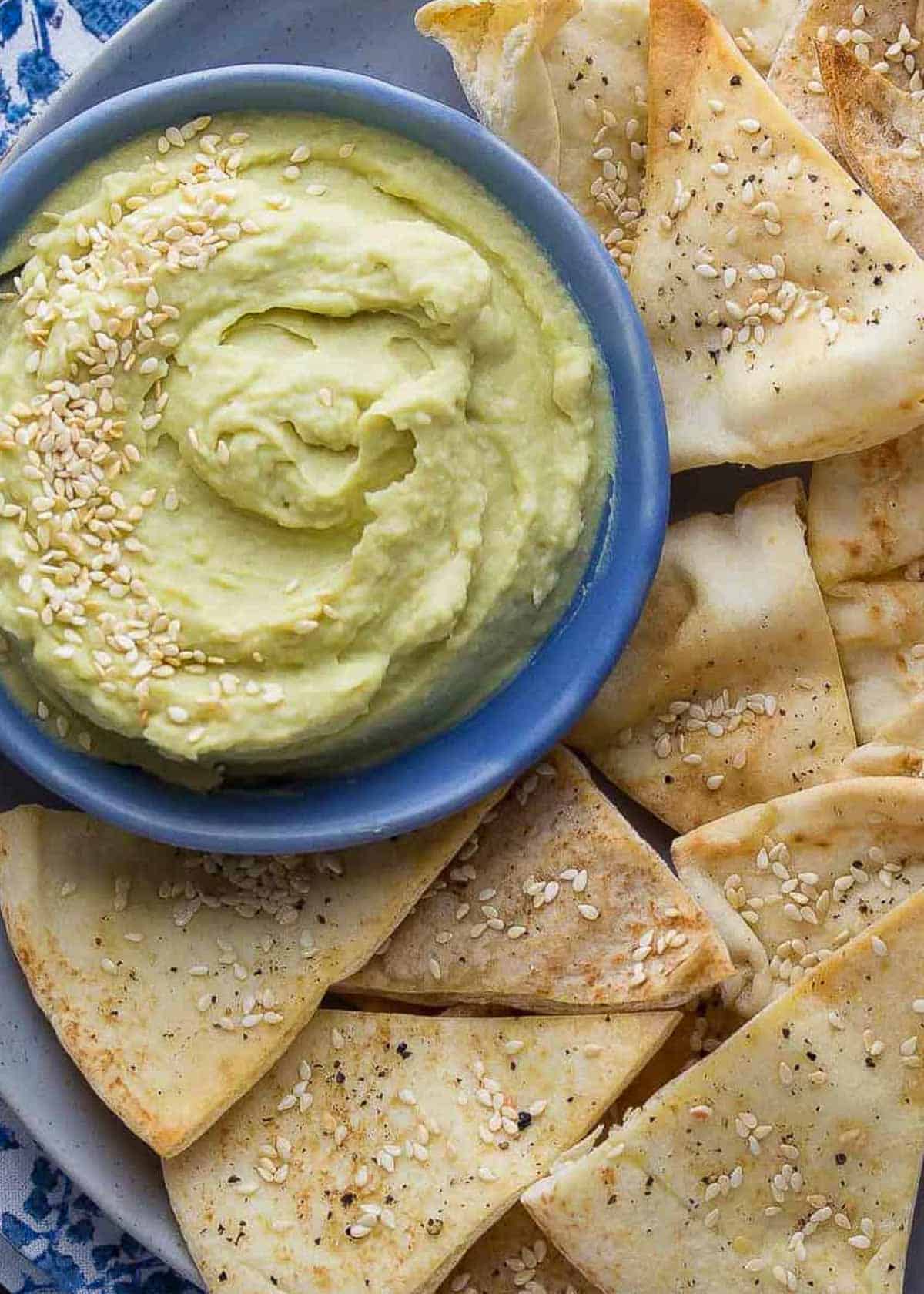 smooth avocado white bean dip with a side of fresh baked pita chips