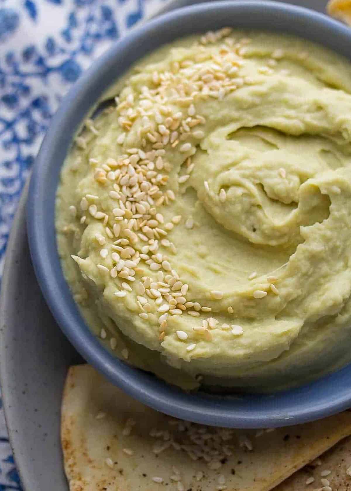 overhead shot showing creamy, spicy white bean dip garnished with sesame seeds
