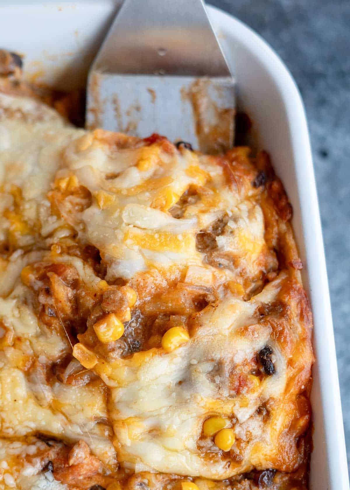 a close up shot of a slice of taco casserole