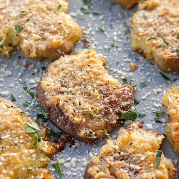 overhead shot of crispy smashed potatoes on a baking sheet