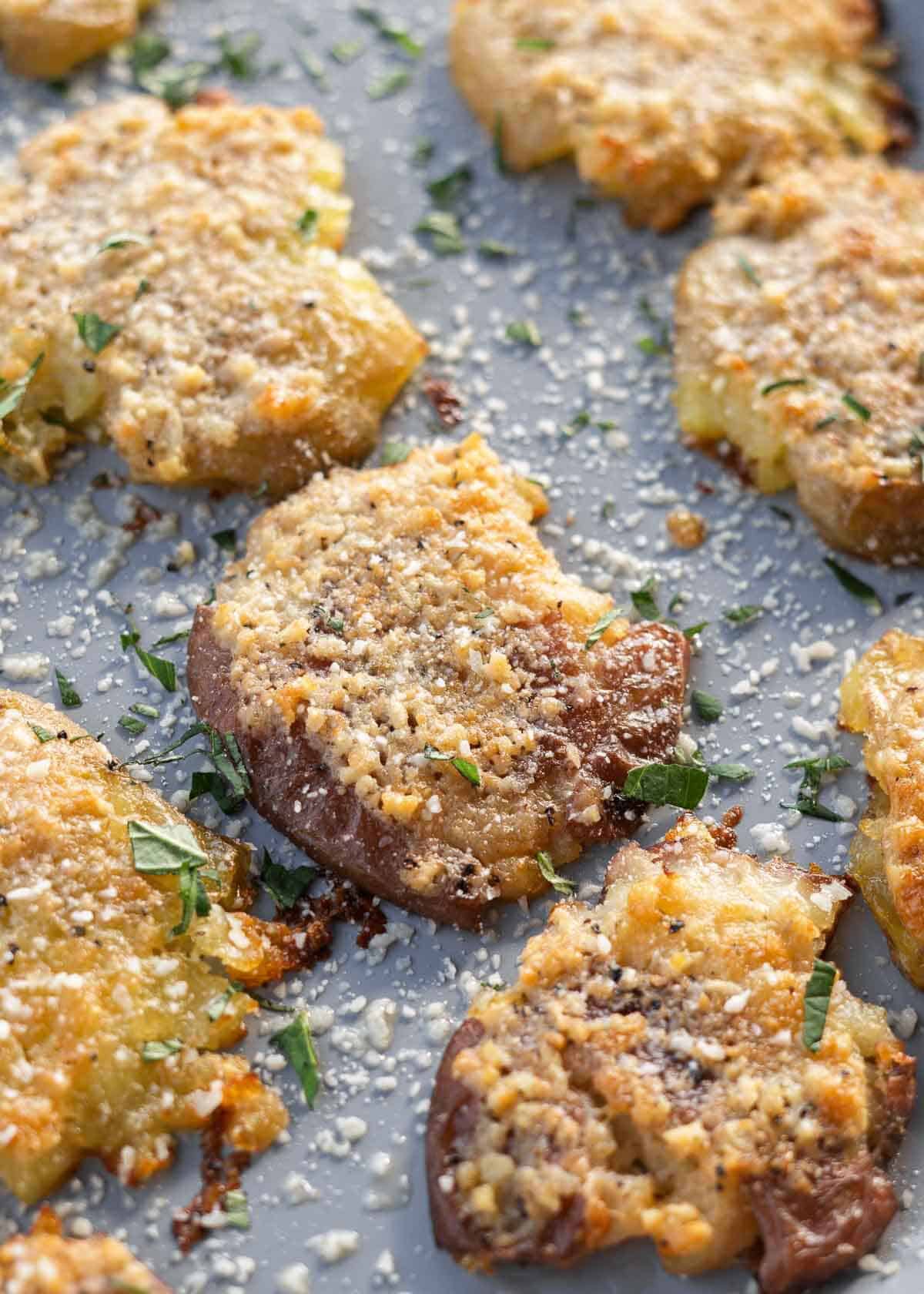 overhead shot of crispy smashed potatoes on a baking sheet