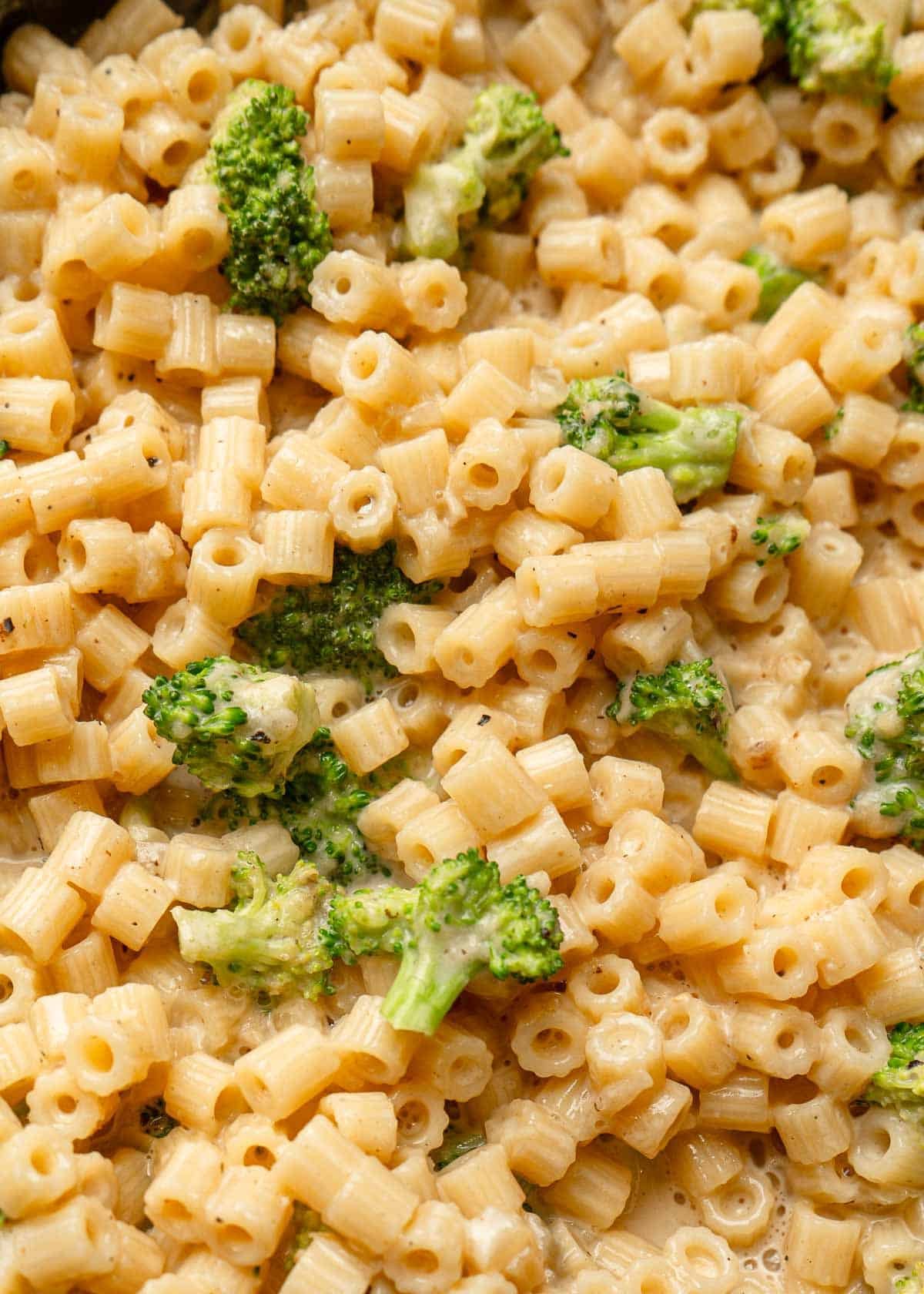 creamy broccoli parmesan pasta in a black skillet