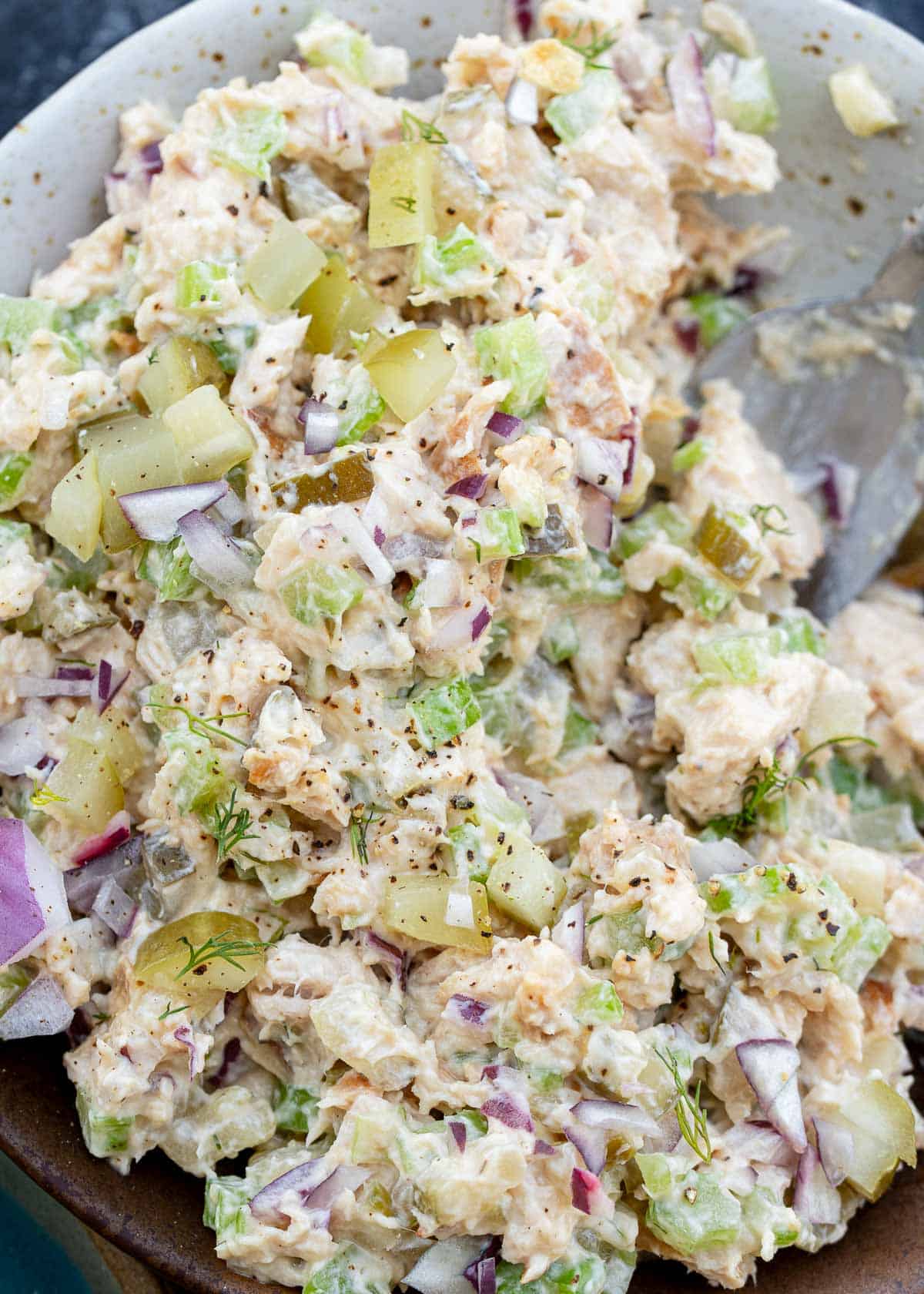 creamy dill pickle chicken salad mixed together in a bowl