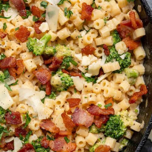 an overhead shot of ditalini pasta with broccoli, bacon and parmesan