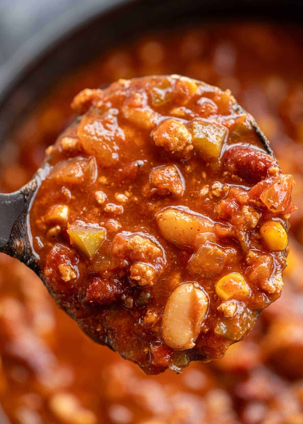 a closeup shot of a ladle of turkey chili