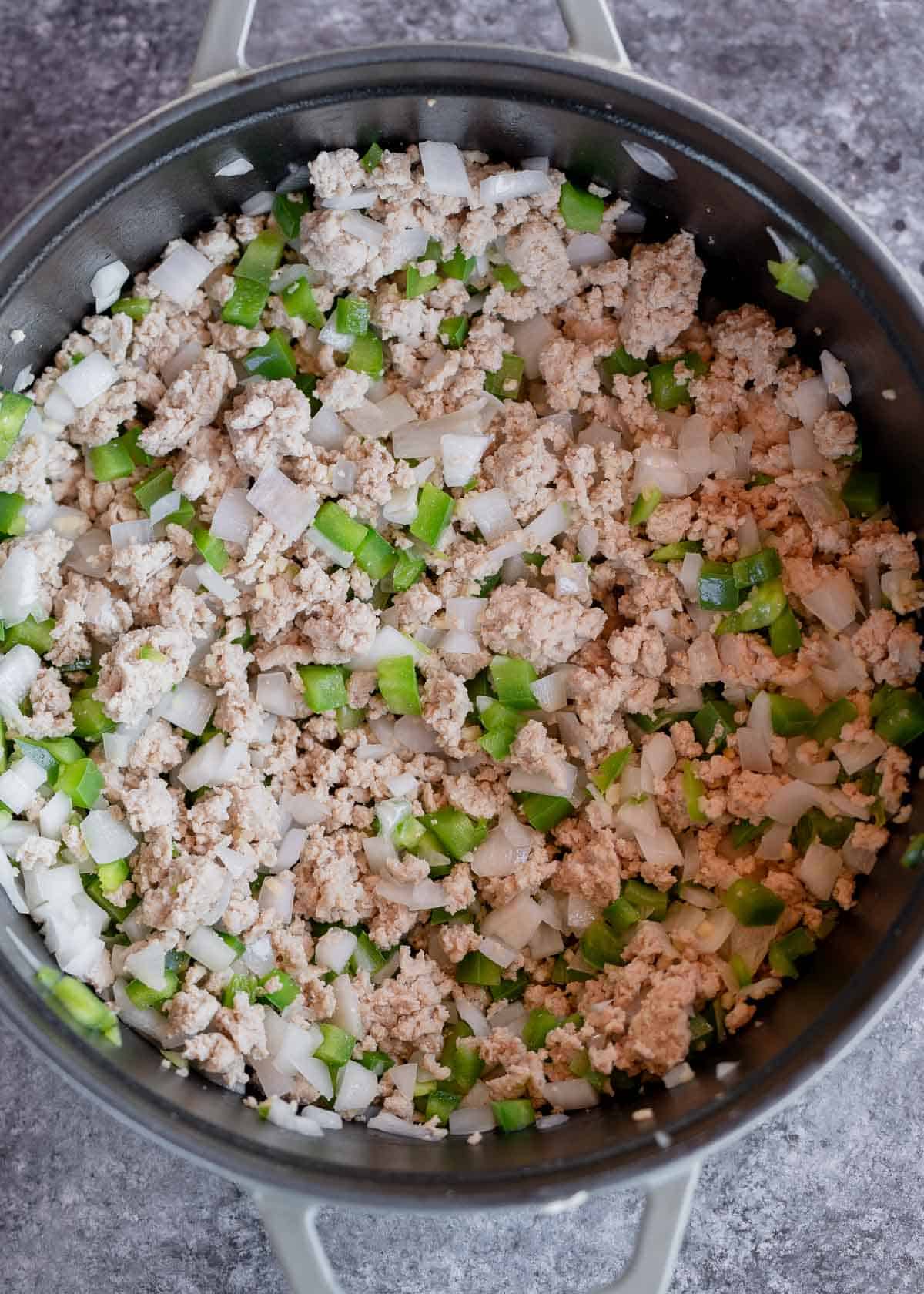 ground turkey, onions and peppers in a dutch oven