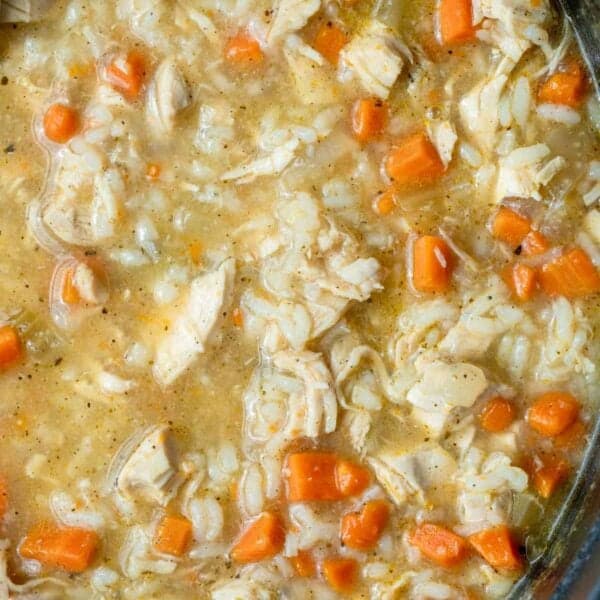 an overhead shot of chicken and rice soup in a dutch oven