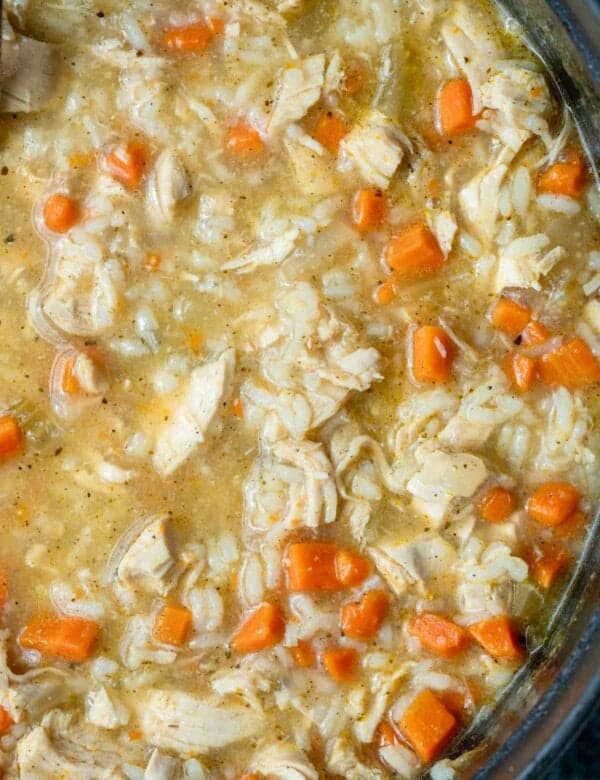 an overhead shot of chicken and rice soup in a dutch oven