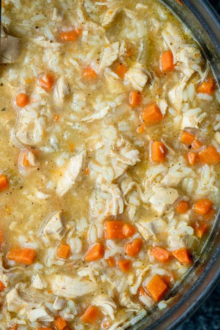 an overhead shot of chicken and rice soup in a dutch oven