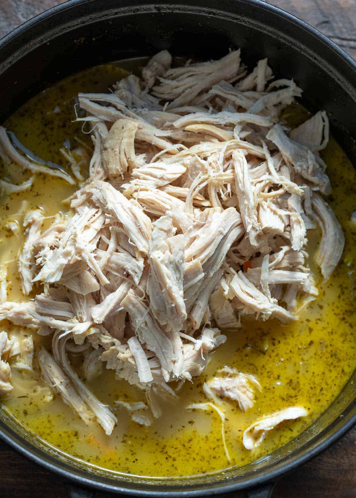 shredded chicken and soup ingredients in a chicken and rice soup