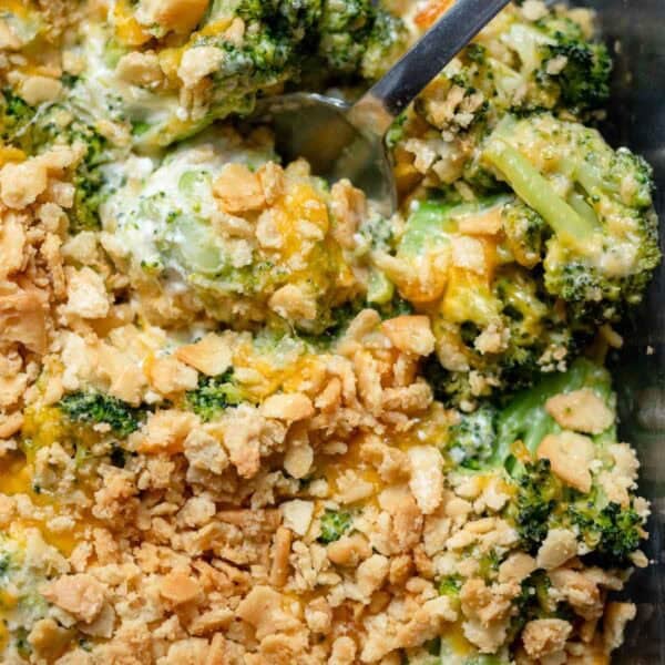 an overhead shot of a cooked broccoli cheese casserole with a spoon in the dish