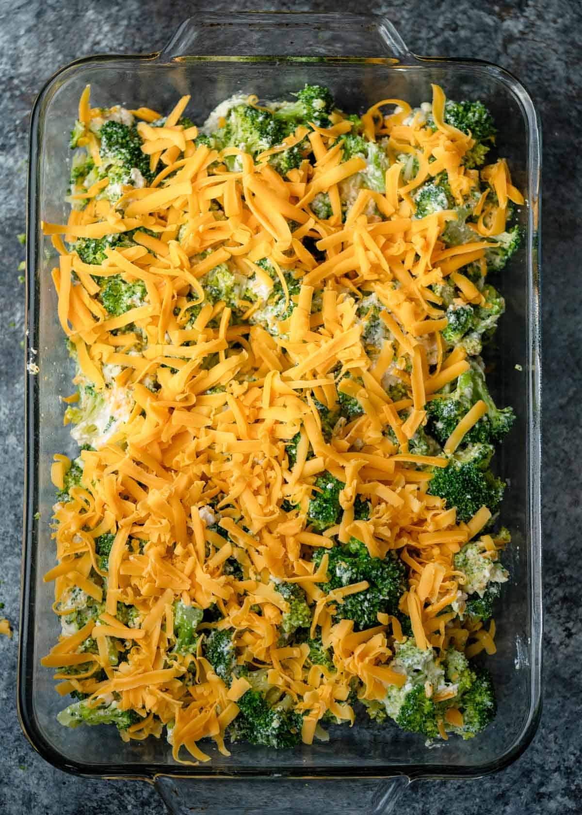 broccoli cheese casserole unbaked in a glass baking dish