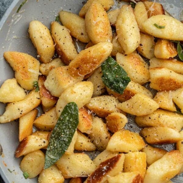 an overhead shot of cottage cheese gnocchi in a skillet with brown butter and sage