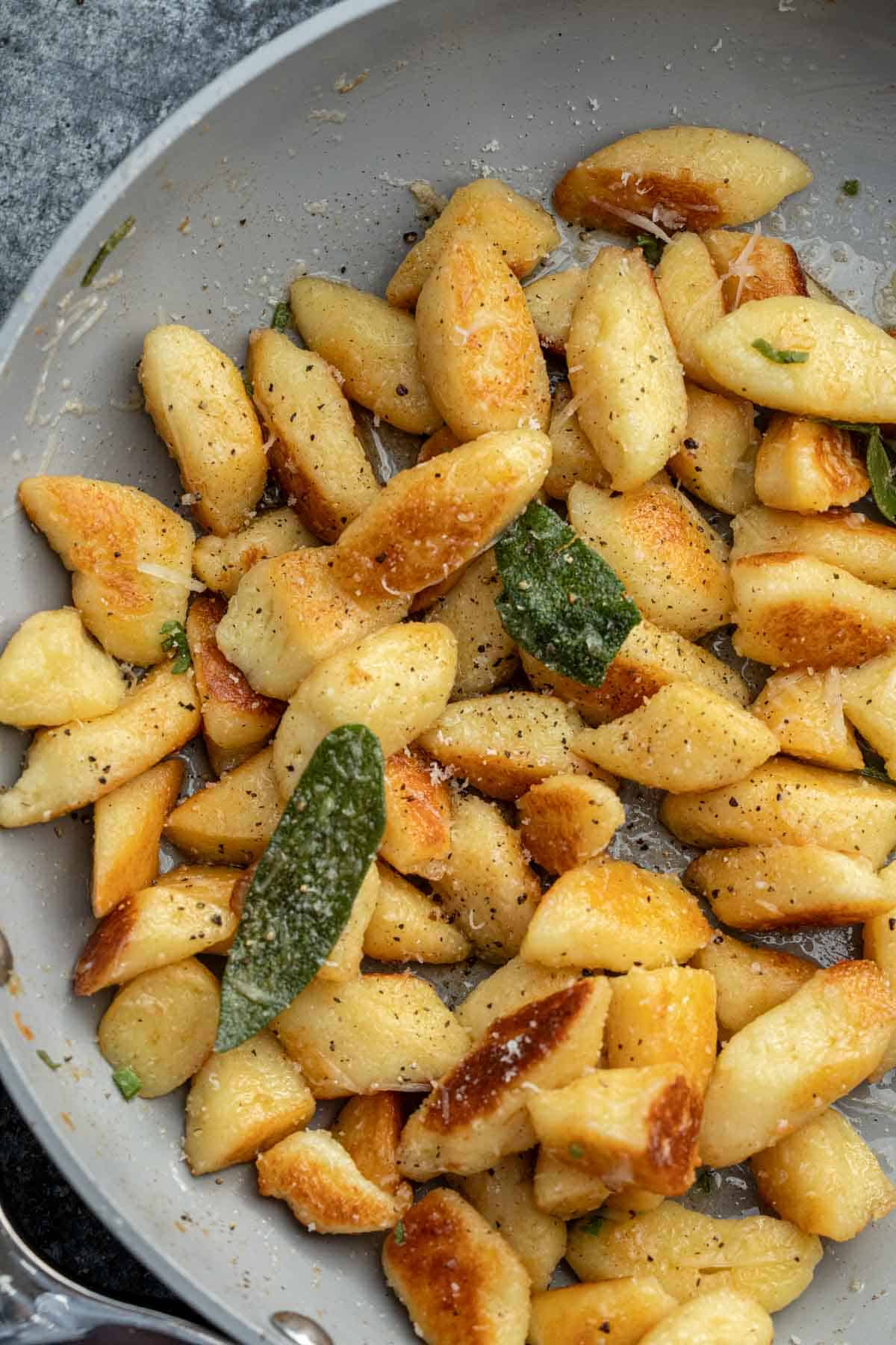 an overhead shot of cottage cheese gnocchi in a skillet with brown butter and sage