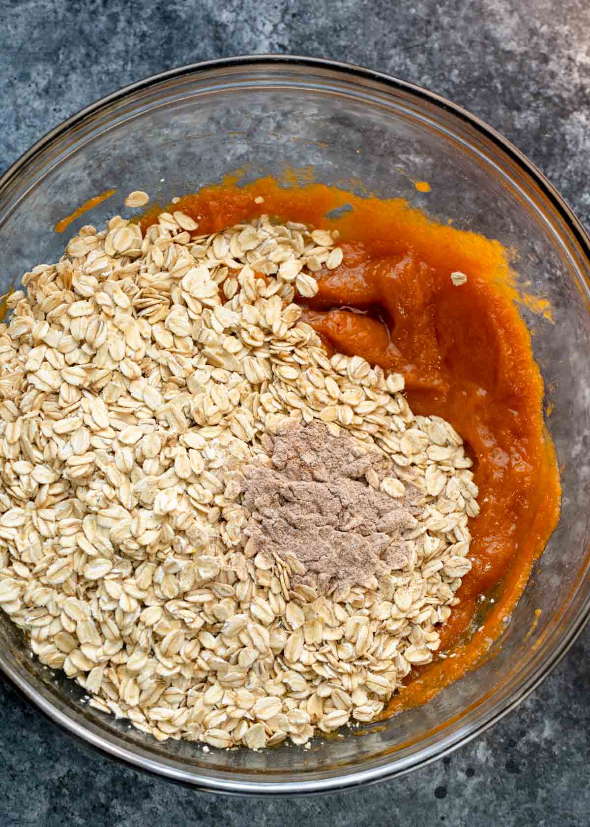 pumpkin, oats and spices in a mixing bowl to make pumpkin spice cookies
