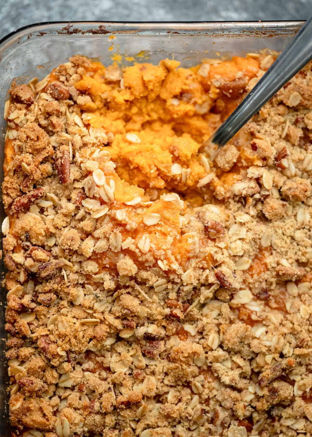 an overhead shot of sweet potato casserole with a spoon