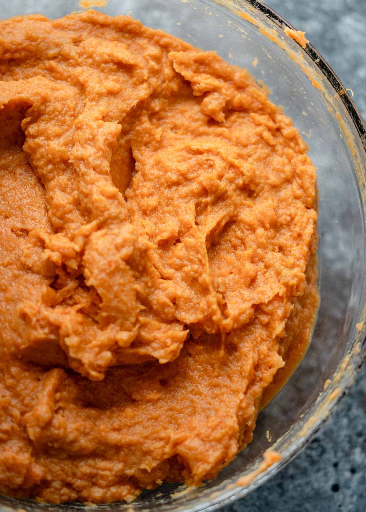 a bowl full of fluffy mashed sweet potato for a casserole