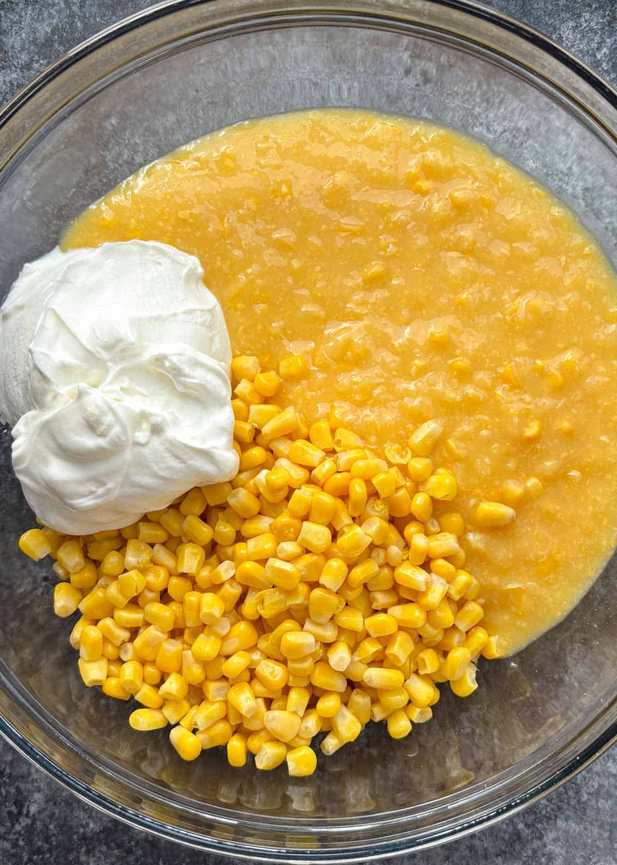 corn casserole in a class dish with sour cream