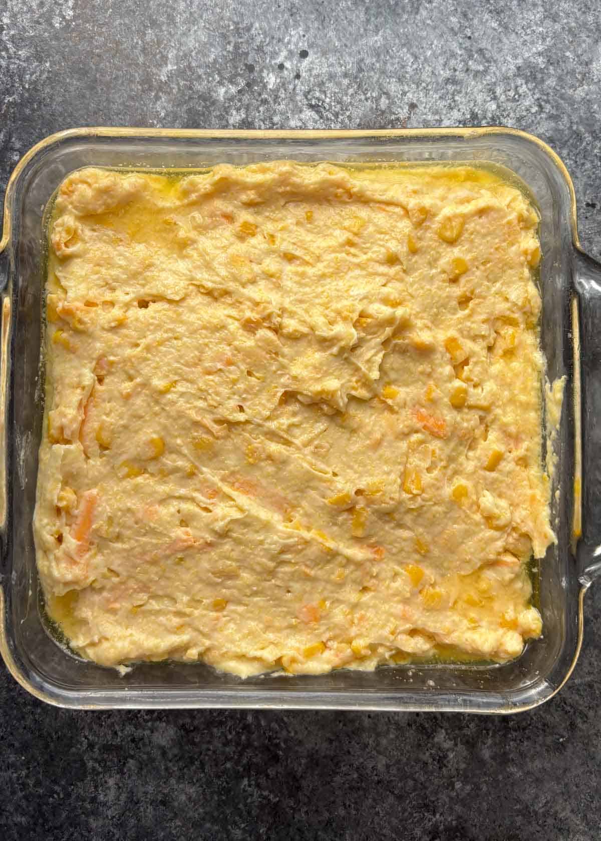 corn casserole batter in a glass dish