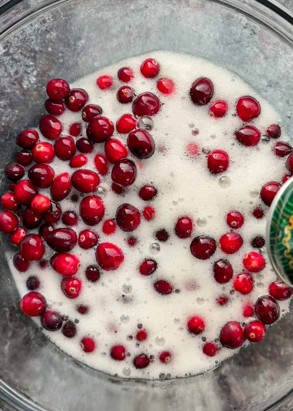 cranberries and ginger ale in a glass bowl