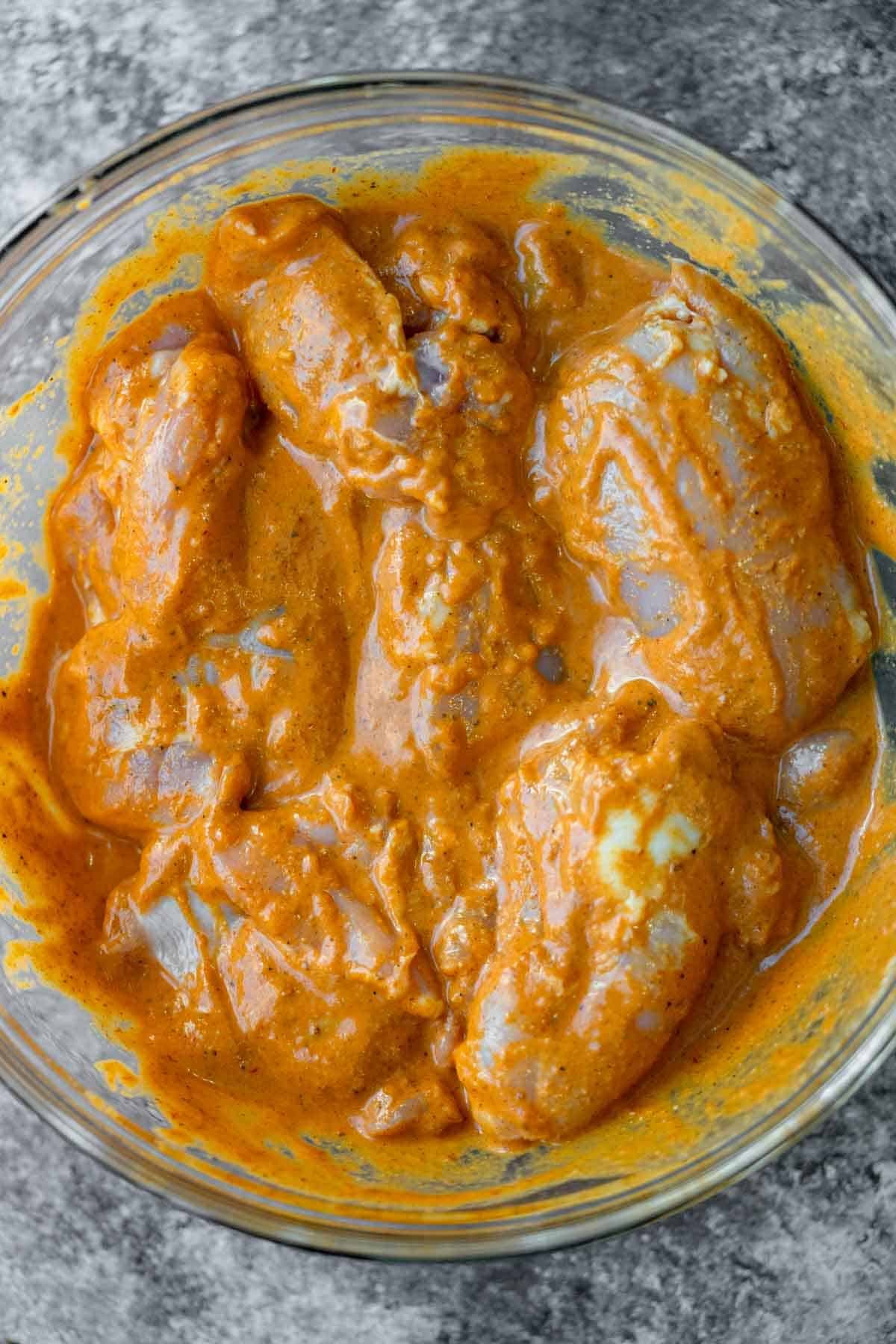 chicken thighs in a bowl covered in chipotle marinade