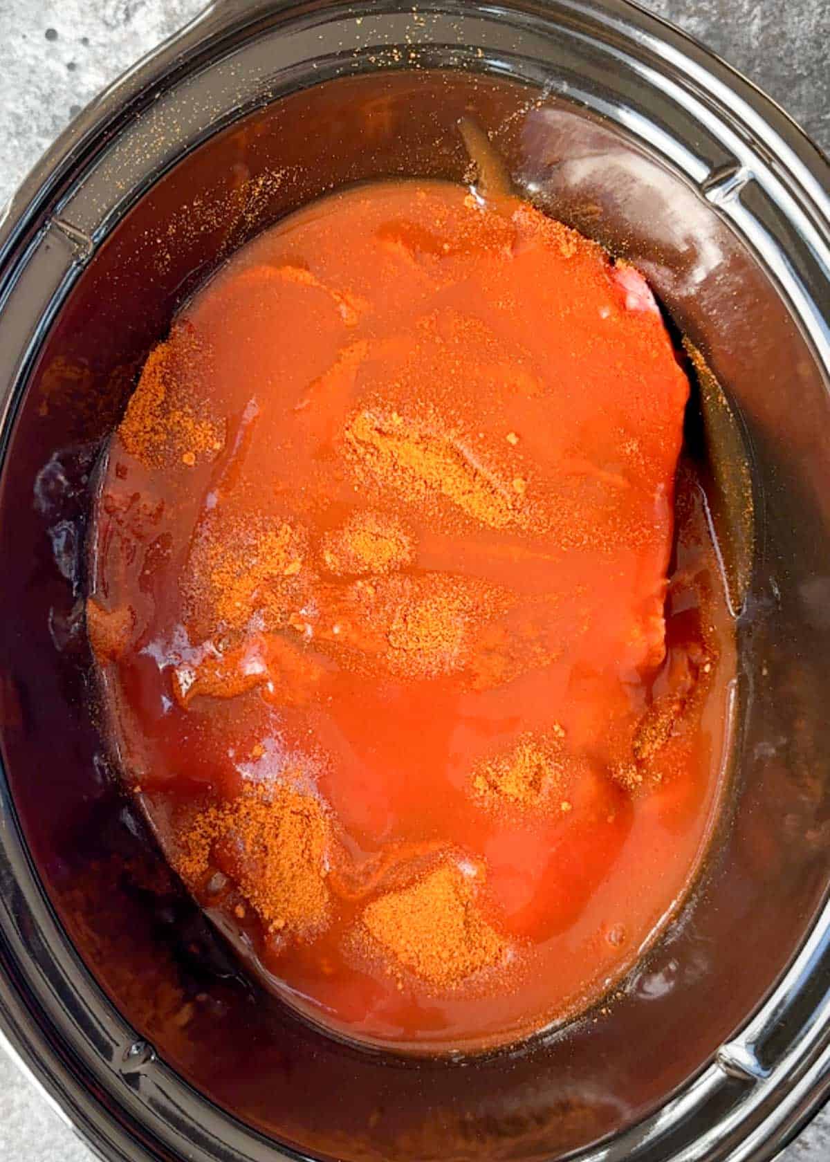 beef roast covered in taco seasoning and enchilada sauce