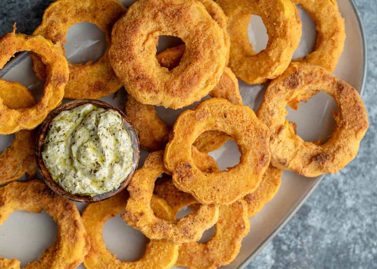 an overhead shot of delicata squash on a platter with pesto aioli