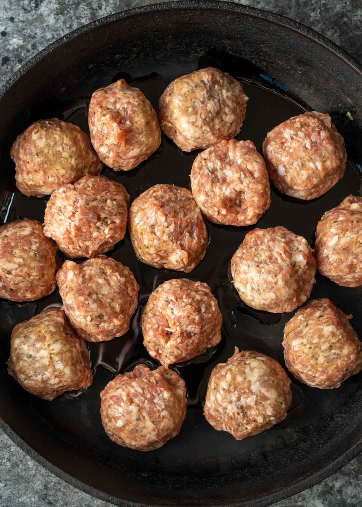 meatballs browning in a skillet