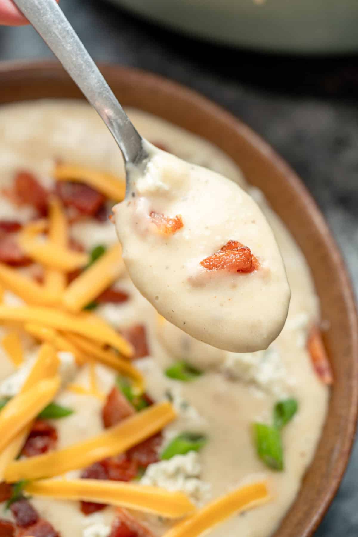 a spoonful of cheesy potato soup with boursin