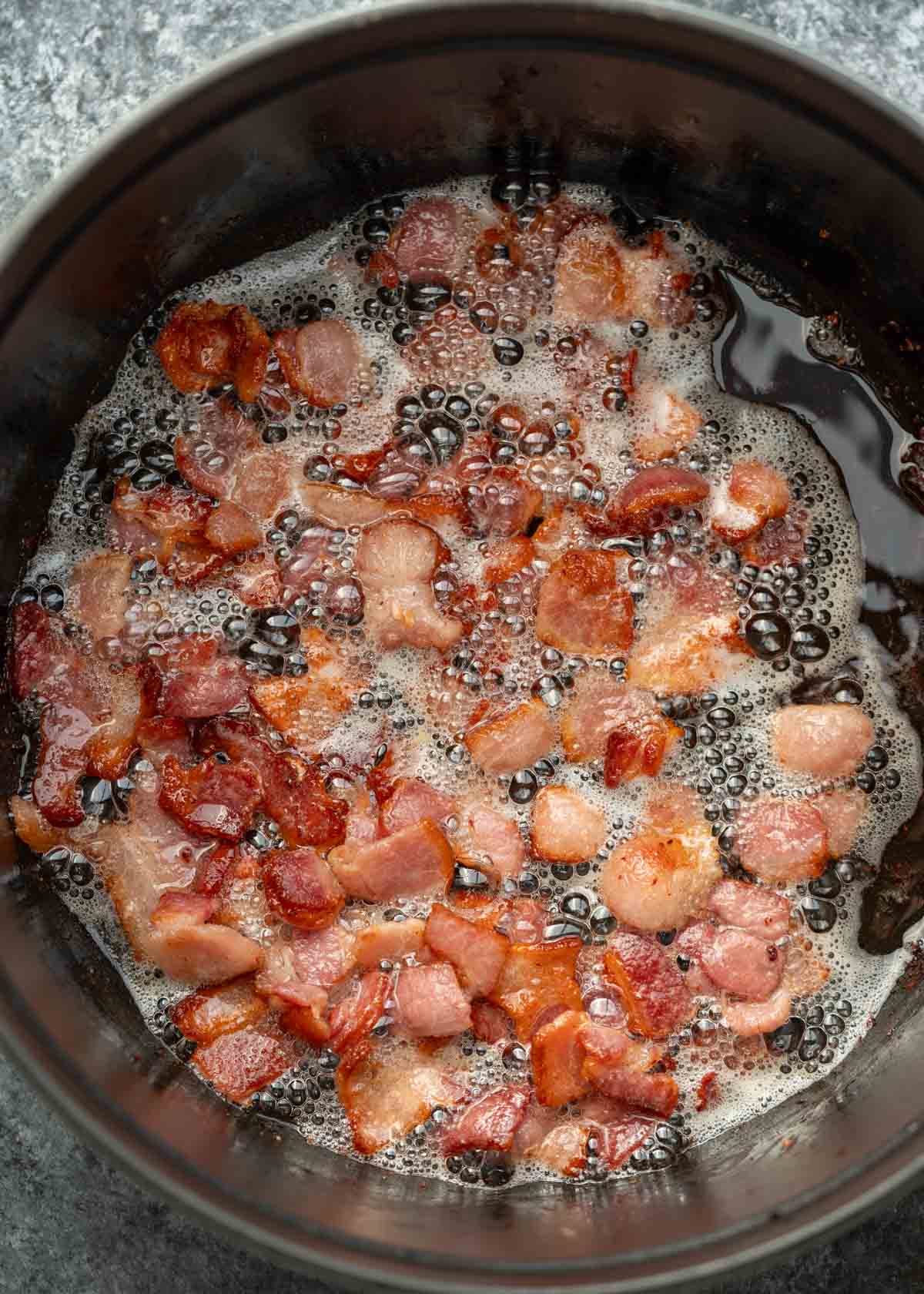 bacon crisping up in a dutch oven