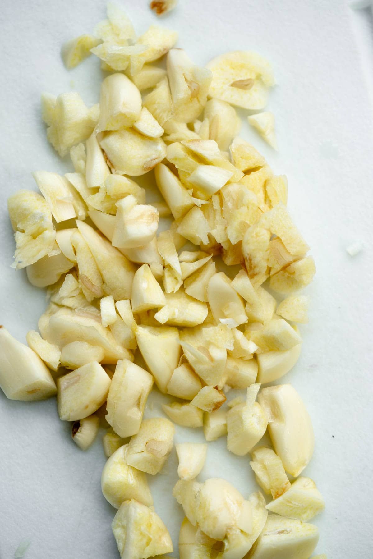 crushed garlic on a cutting board