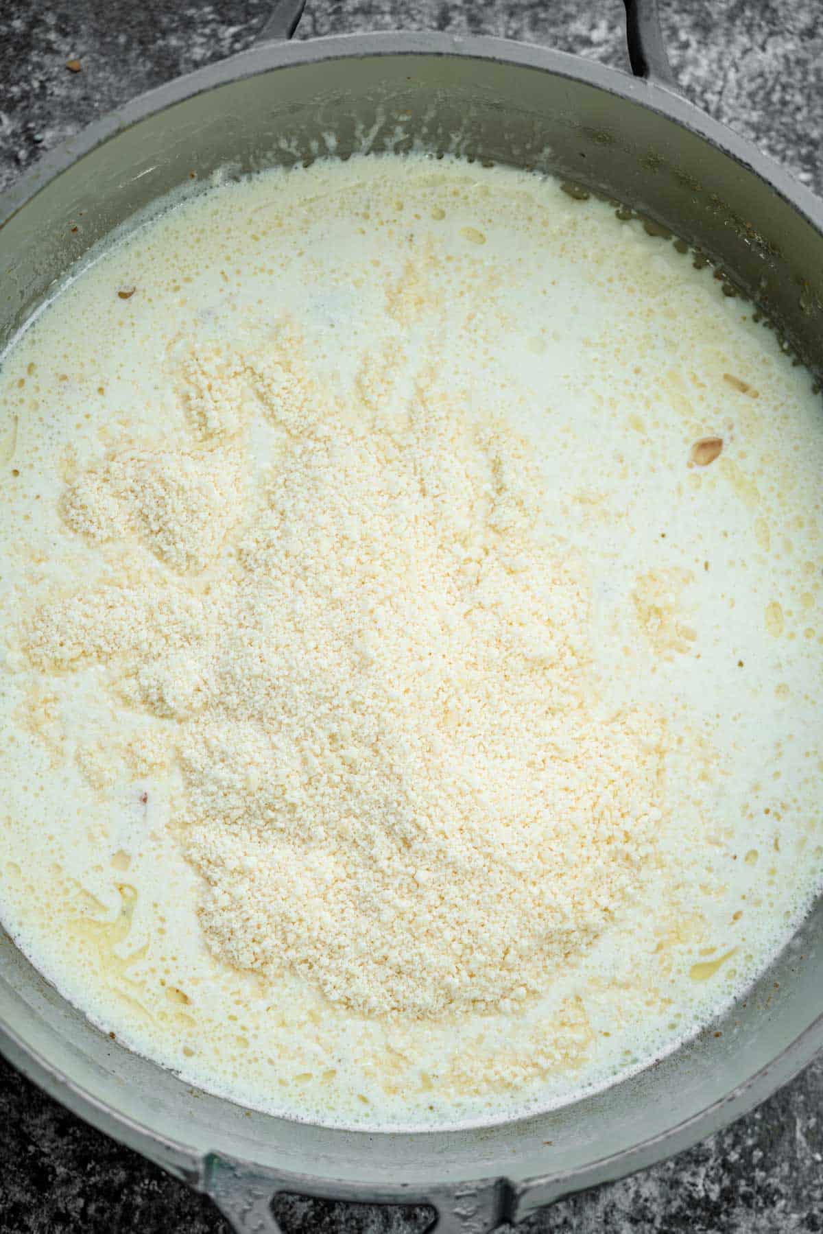 heavy cream and parmesan in a skillet