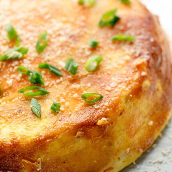 a close up of an unsliced spanish sweet potato omelette