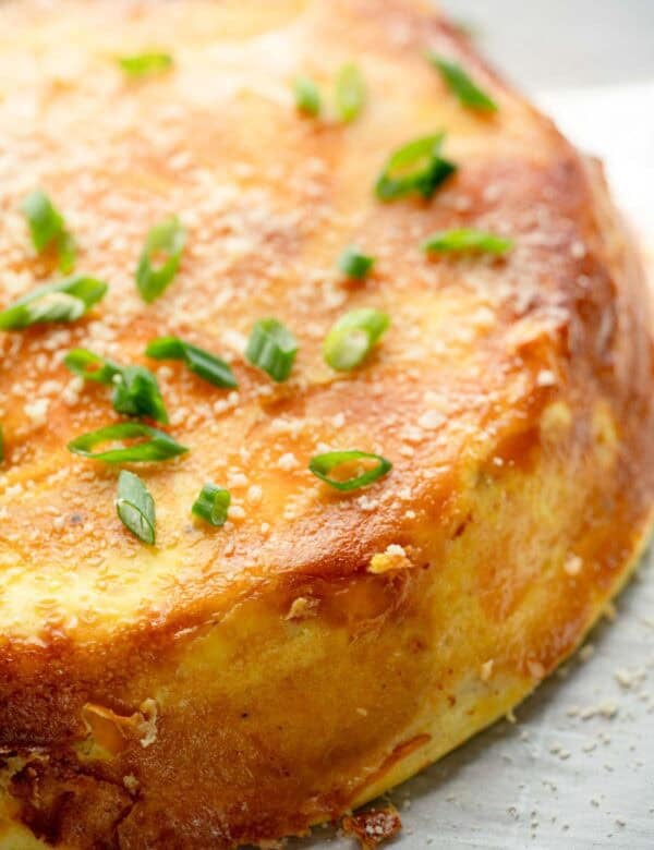 a close up of an unsliced spanish sweet potato omelette