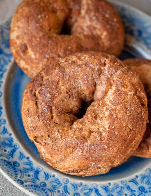 close up, overhead image of cinnamon protein bagels on a blue plate