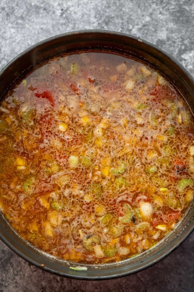 italian sausage, vegetables and broth in a pot