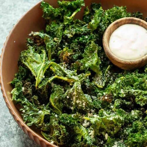 overhead image of kale chips and dip in a brown bowl