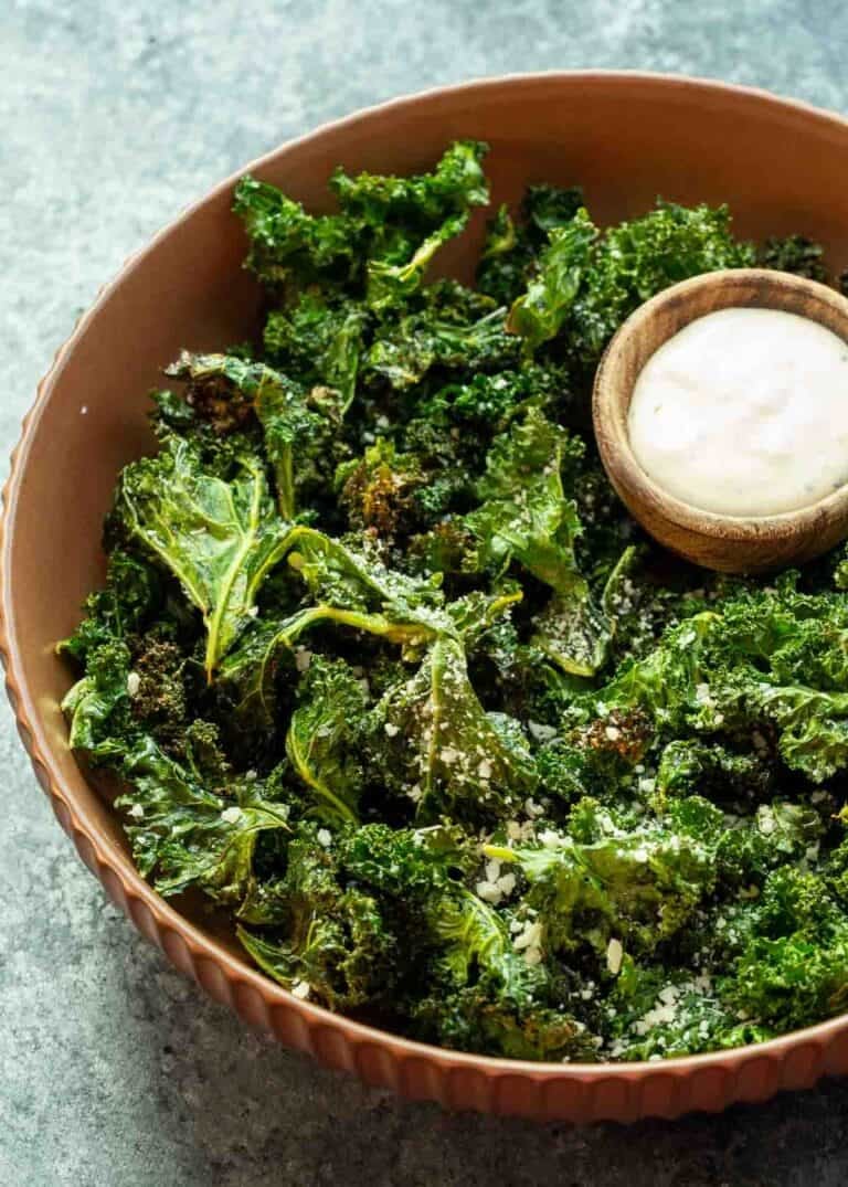 overhead image of kale chips and dip in a brown bowl