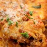 cheesy baked tortellini topped with fresh herbs and parmesan