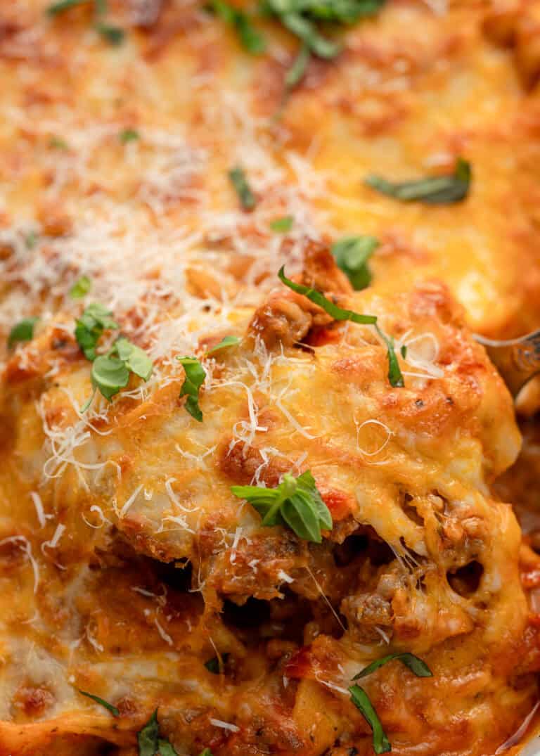 cheesy baked tortellini topped with fresh herbs and parmesan