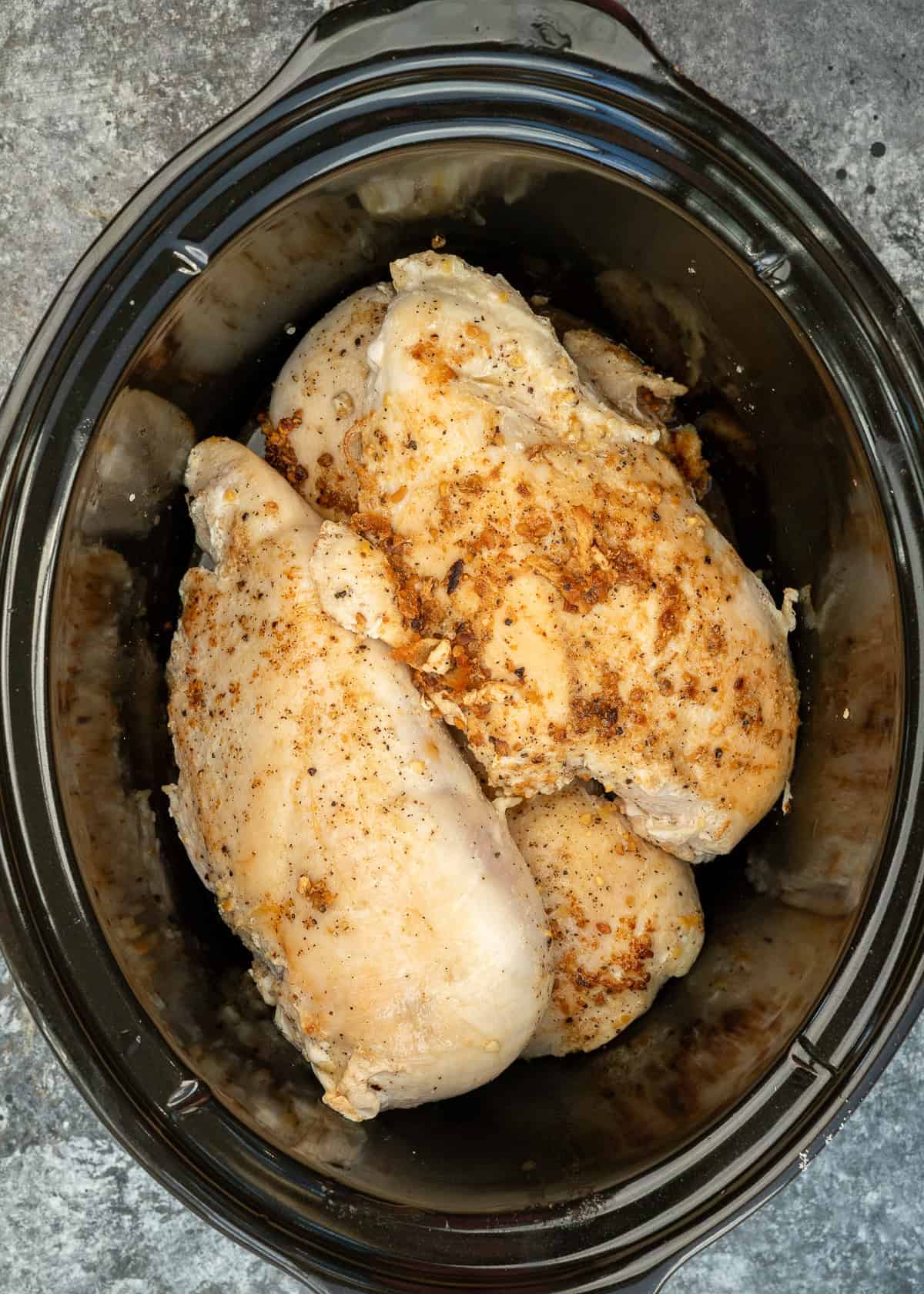 browned chicken in a slow cooker