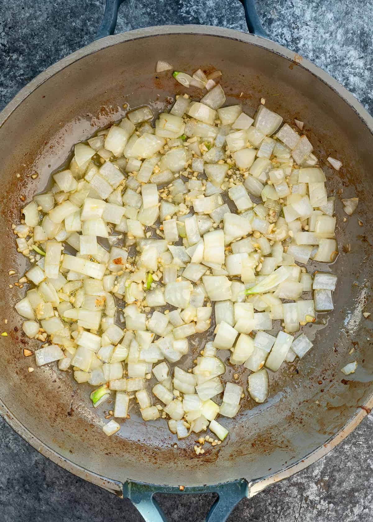 chopped onions sautéing in a pan 