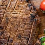 sliced carne asada on wooden cutting board