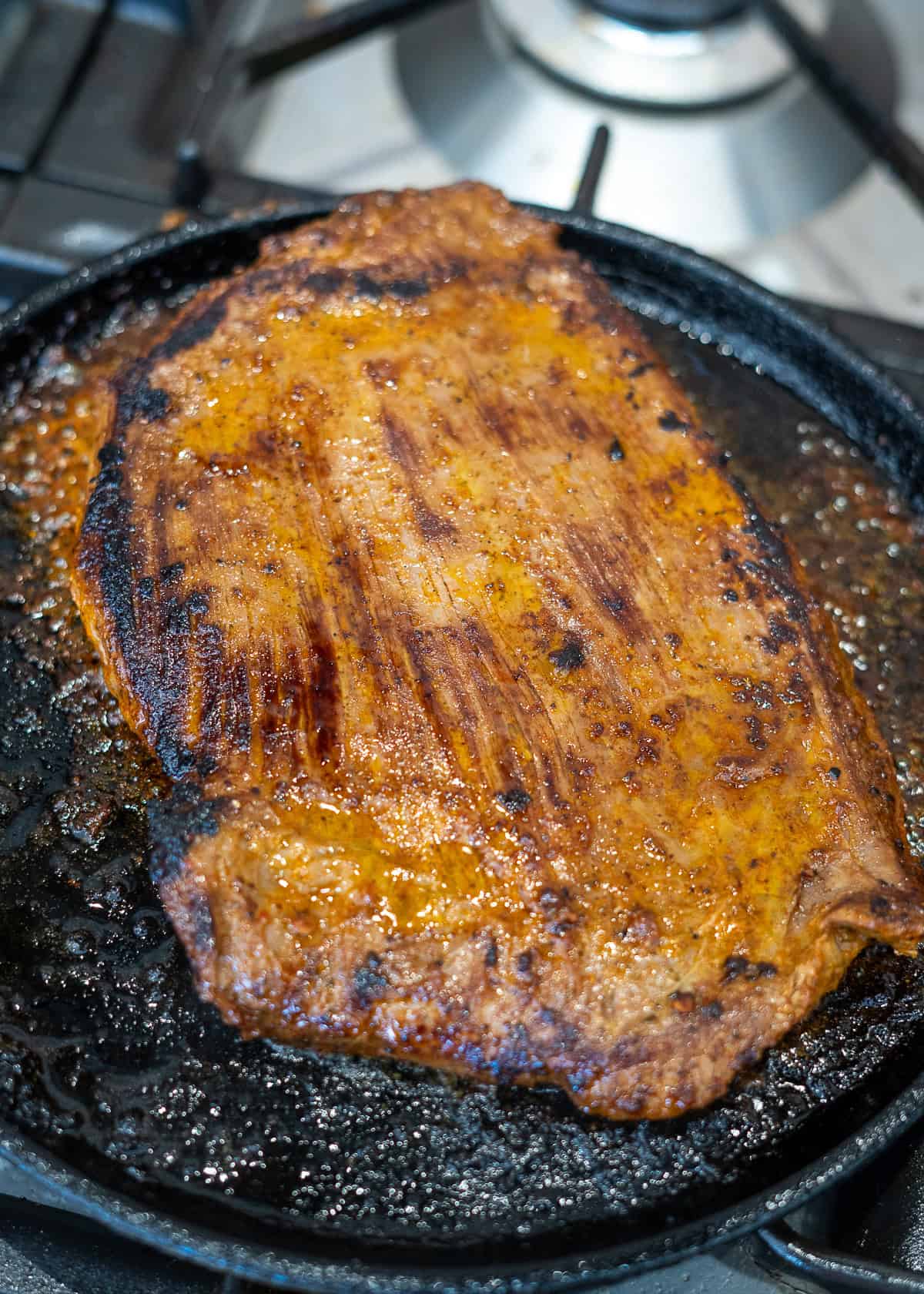 cooked carne asada in cast iron skillet