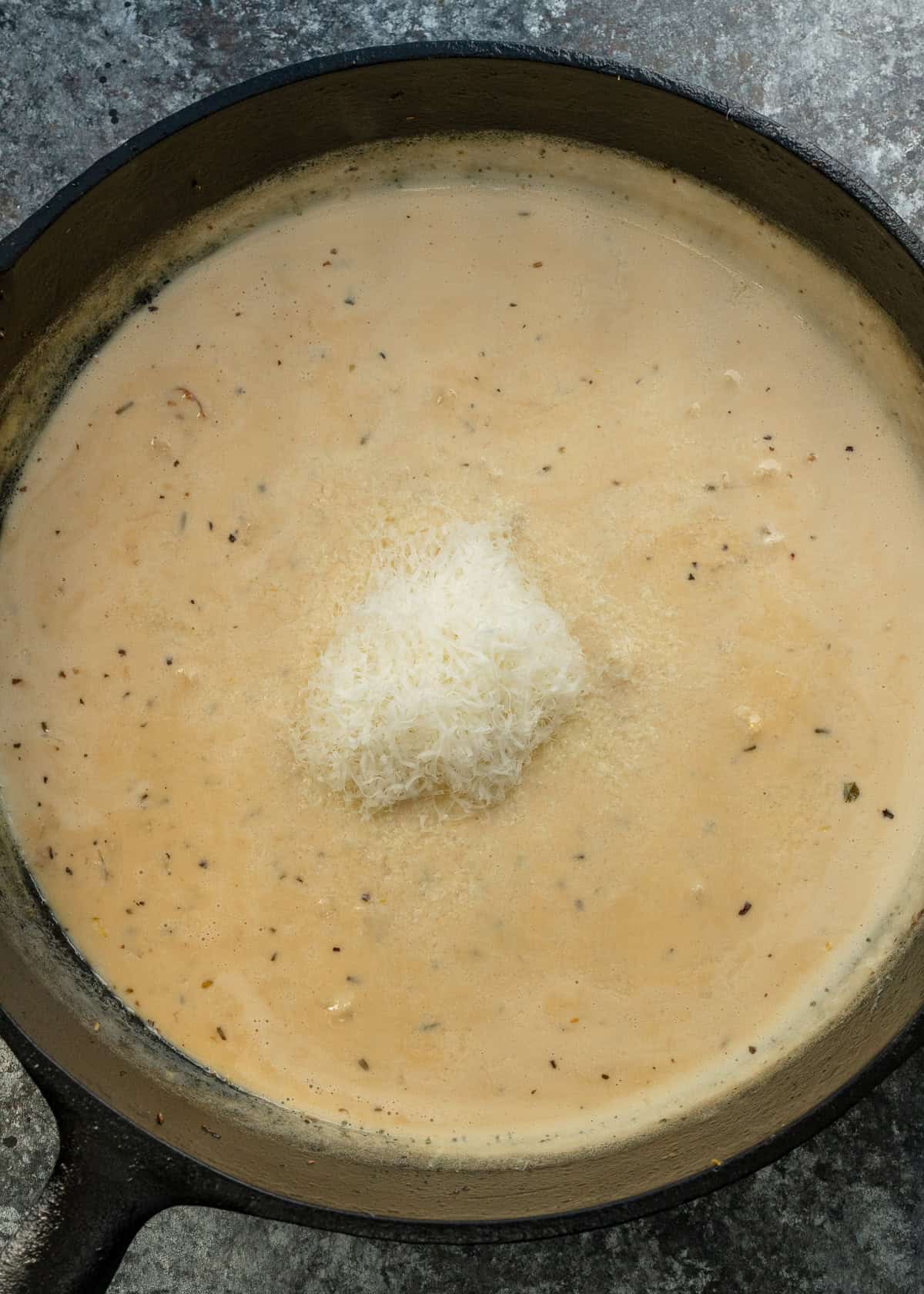 a creamy, lemon garlic sauce in a cast iron skillet