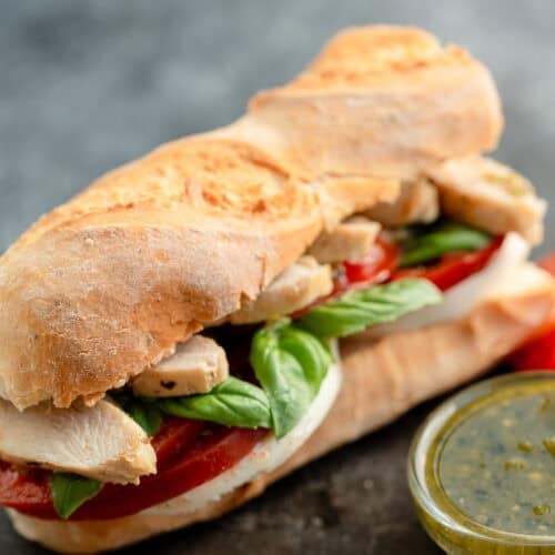 overhead, angled image of pesto sandwich on stone countertop