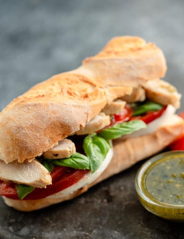 overhead, angled image of pesto sandwich on stone countertop