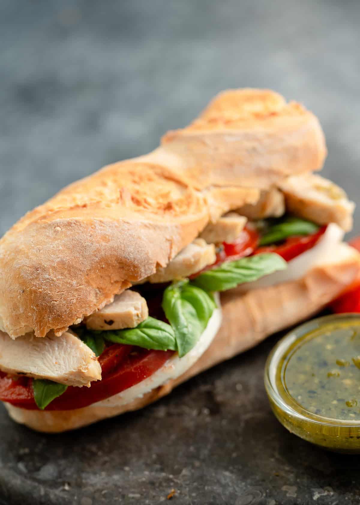 overhead, angled image of pesto sandwich on stone countertop