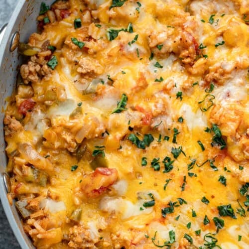 melty cheese and chopped herbs atop an easy stuffed pepper skillet