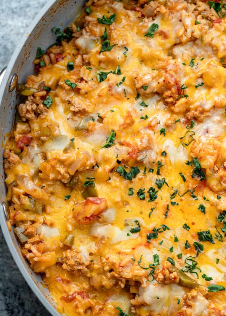 melty cheese and chopped herbs atop an easy stuffed pepper skillet